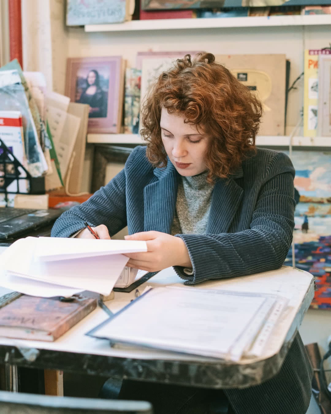 Woman thinking about how to price oil paintings